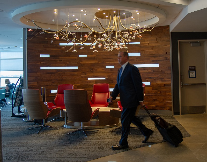 Customer walks by an elaborate chandlier in the reopened D.C. Sky Club